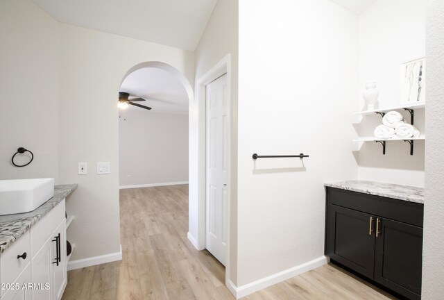 18818 N 95th Ave, Peoria, AZ 85382 - bathroom featuring baseboards, wood finished floors, ceiling fan, and vanity