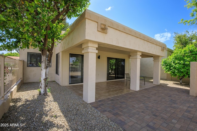 18818 N 95th Ave, Peoria, AZ 85382 - rear view of house with stucco siding, fence, and a patio area