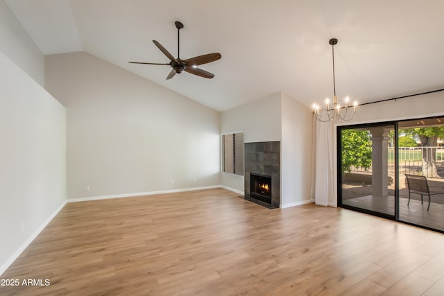 18818 N 95th Ave, Peoria, AZ 85382 - unfurnished living room with a tiled fireplace, ceiling fan with notable chandelier, baseboards, and light wood-type flooring