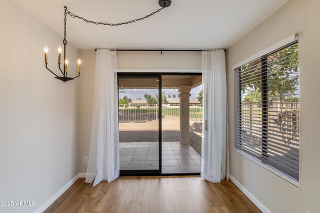 18818 N 95th Ave, Peoria, AZ 85382 - interior space with an inviting chandelier, wood finished floors, baseboards, and a wealth of natural light