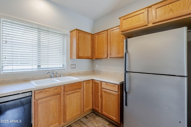 14881 W Ashland Ave, Goodyear, AZ 85395 - kitchen with freestanding refrigerator, dishwasher, a sink, and light countertops