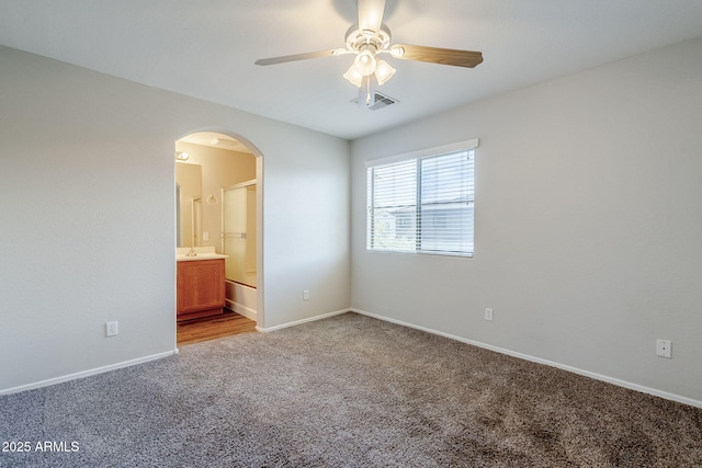 14881 W Ashland Ave, Goodyear, AZ 85395 - carpeted spare room with arched walkways, ceiling fan, and baseboards