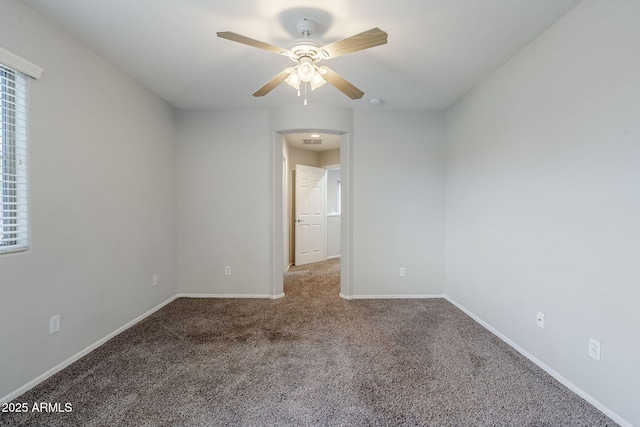 14881 W Ashland Ave, Goodyear, AZ 85395 - carpeted spare room featuring ceiling fan, baseboards, and arched walkways