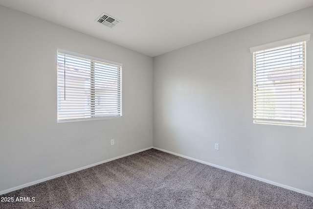 14881 W Ashland Ave, Goodyear, AZ 85395 - unfurnished room featuring healthy amount of natural light, carpet, and baseboards
