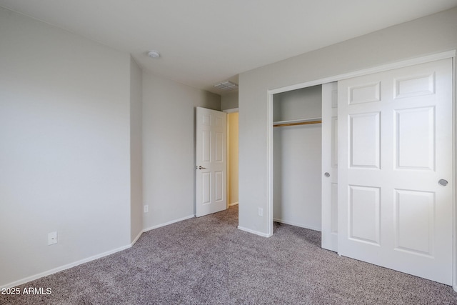 14881 W Ashland Ave, Goodyear, AZ 85395 - unfurnished bedroom featuring carpet floors, a closet, and baseboards