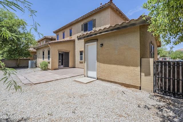 14881 W Ashland Ave, Goodyear, AZ 85395 - back of house with stucco siding, a tiled roof, central AC, and a patio
