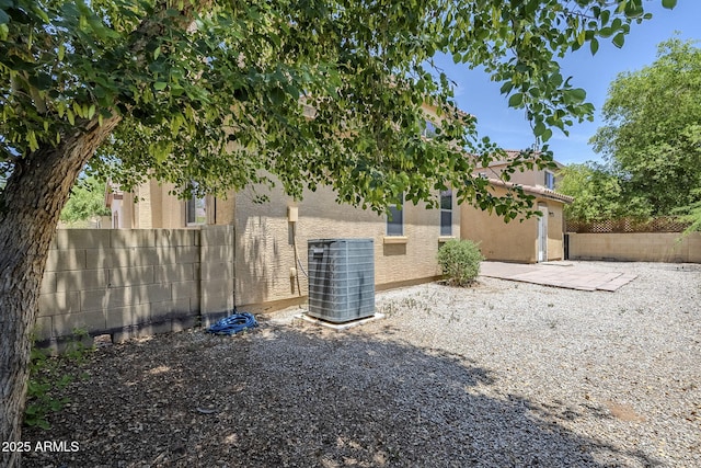 14881 W Ashland Ave, Goodyear, AZ 85395 - view of side of property with central AC, a fenced backyard, stucco siding, and a patio