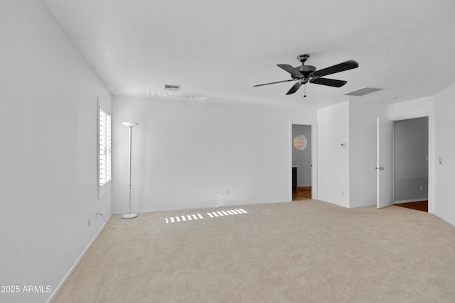 carpeted spare room with ceiling fan