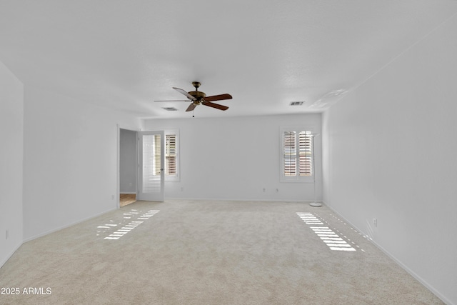 carpeted spare room featuring ceiling fan