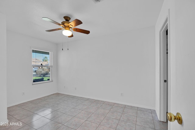 tiled empty room featuring ceiling fan