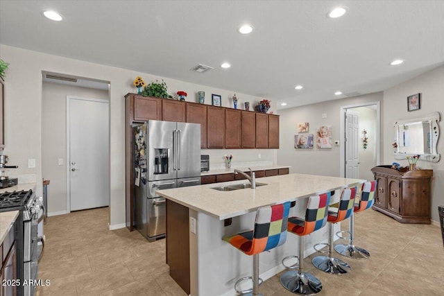 22912 E Domingo Rd, Queen Creek, AZ 85142 - kitchen featuring stainless steel appliances, a kitchen island with sink, a sink, visible vents, and recessed lighting