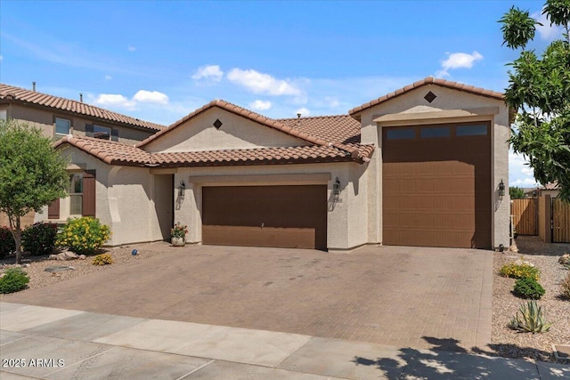 22912 E Domingo Rd, Queen Creek, AZ 85142 - mediterranean / spanish-style home with a garage, a tiled roof, and stucco siding