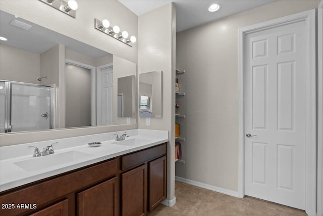 22912 E Domingo Rd, Queen Creek, AZ 85142 - full bathroom with double vanity, a shower with shower door, baseboards, and a sink