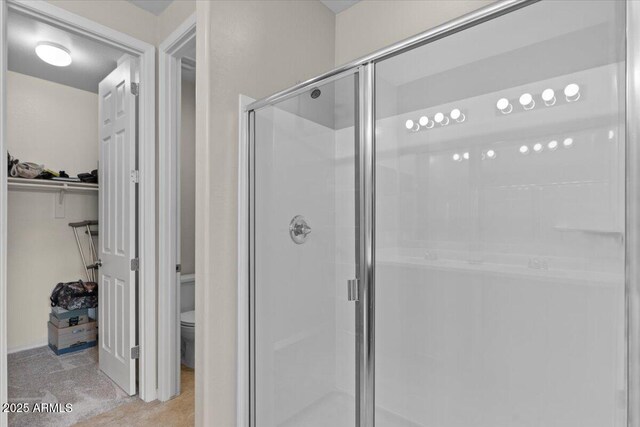 22912 E Domingo Rd, Queen Creek, AZ 85142 - bathroom featuring a spacious closet, toilet, and a stall shower