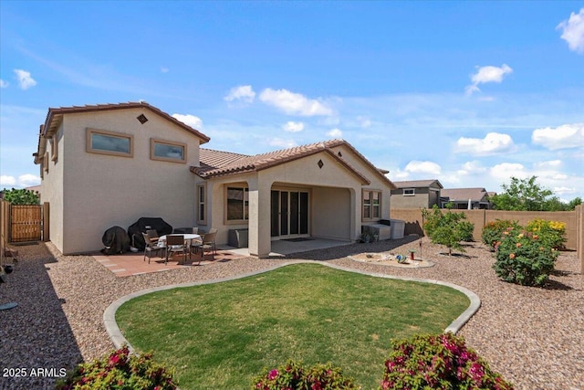 22912 E Domingo Rd, Queen Creek, AZ 85142 - rear view of house featuring a tile roof, a patio area, a lawn, a fenced backyard, and stucco siding