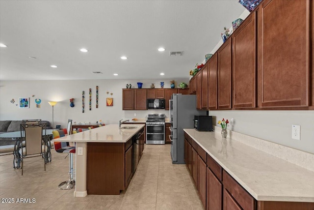22912 E Domingo Rd, Queen Creek, AZ 85142 - kitchen with stainless steel appliances, a sink, light tile patterned flooring, visible vents, and light countertops