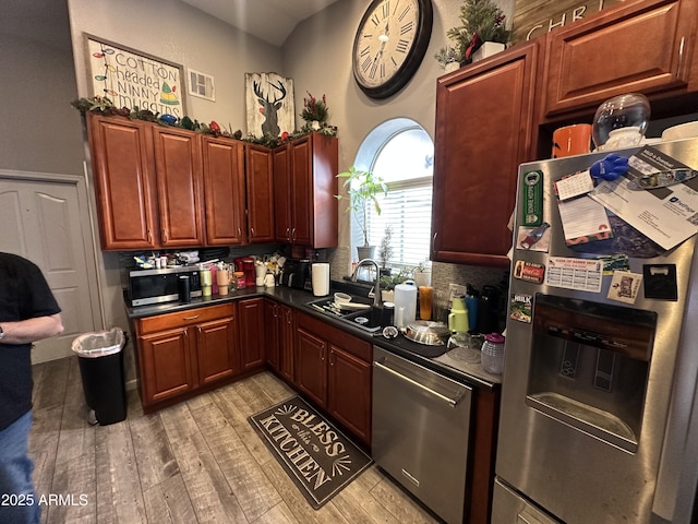 kitchen with sink, light hardwood / wood-style flooring, and appliances with stainless steel finishes