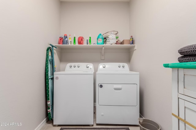 clothes washing area with separate washer and dryer