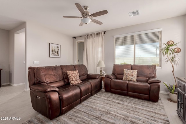 living room featuring ceiling fan and light wood-type flooring