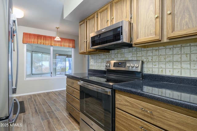 19417 N Palo Verde Dr, Sun City, AZ 85373 - kitchen with stainless steel appliances, baseboards, dark wood finished floors, backsplash, and dark countertops