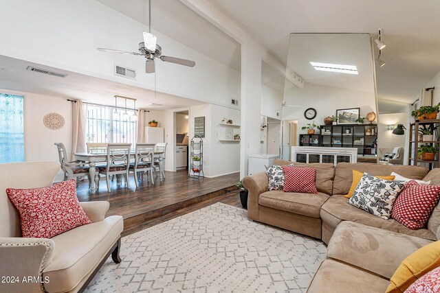 living room featuring hardwood / wood-style floors, high vaulted ceiling, and ceiling fan