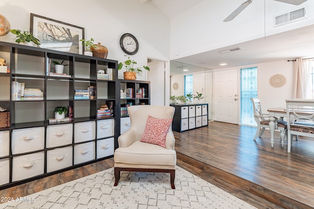 sitting room with ceiling fan and wood-type flooring