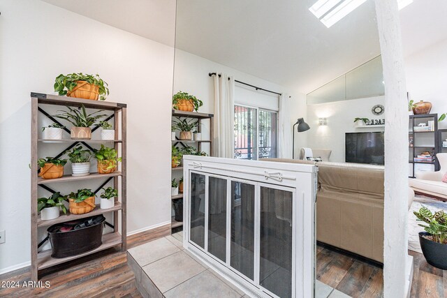 living room featuring lofted ceiling and hardwood / wood-style flooring