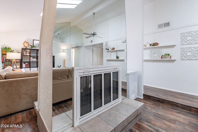 stairs featuring hardwood / wood-style flooring, high vaulted ceiling, beamed ceiling, and ceiling fan