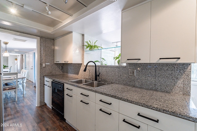 kitchen featuring decorative backsplash, pendant lighting, dark hardwood / wood-style flooring, dishwasher, and sink