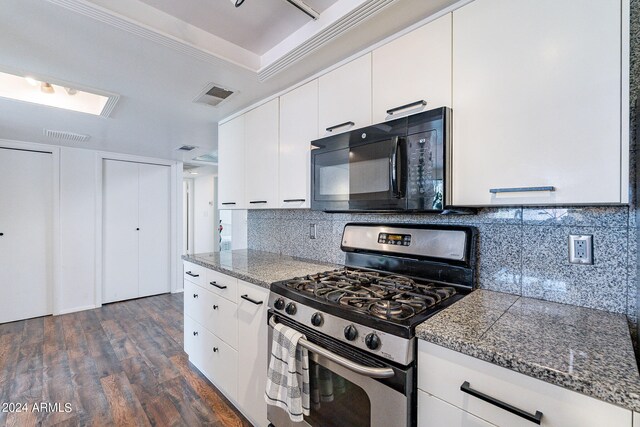 kitchen with white cabinetry, dark hardwood / wood-style floors, gas stove, and tasteful backsplash