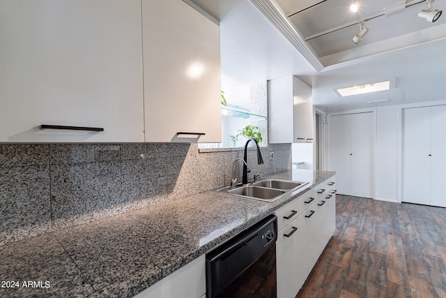 kitchen with sink, tasteful backsplash, track lighting, dishwasher, and white cabinetry