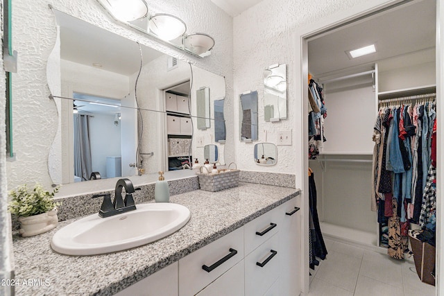 bathroom featuring tile patterned flooring and vanity