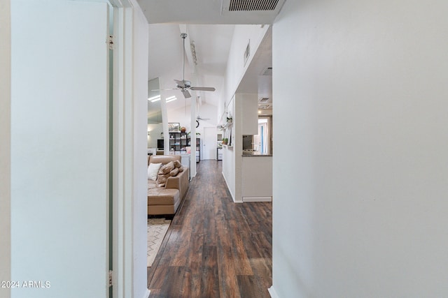 hallway with dark hardwood / wood-style floors and lofted ceiling