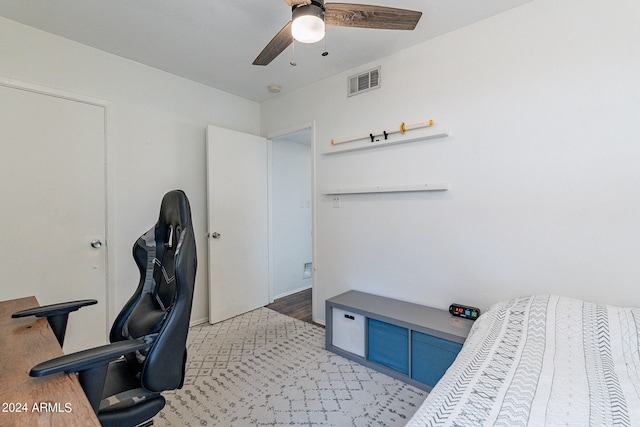 carpeted home office featuring ceiling fan