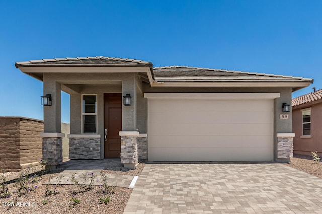 5649 N 205th Ln, Buckeye, AZ 85396 - prairie-style home featuring a garage, decorative driveway, a tile roof, and stone siding