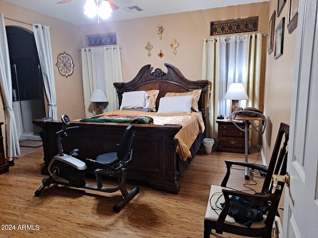 bedroom with hardwood / wood-style flooring and ceiling fan