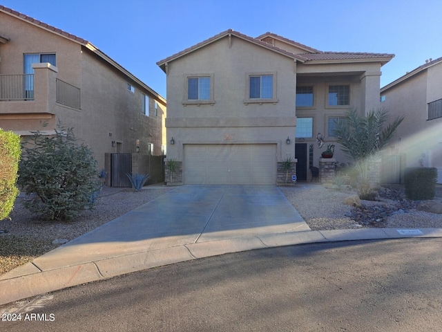 view of front of home featuring a garage and central AC