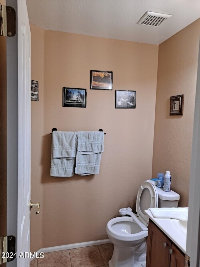 bathroom with vanity, tile patterned floors, and toilet