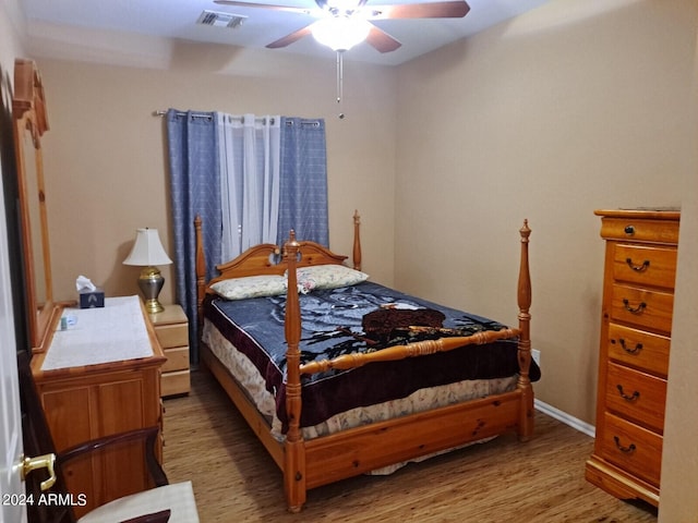 bedroom featuring wood-type flooring and ceiling fan