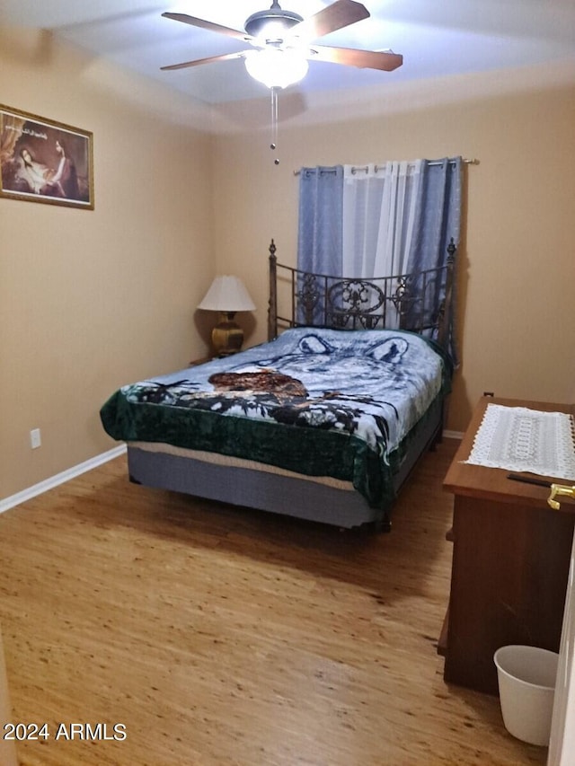 bedroom with hardwood / wood-style flooring and ceiling fan