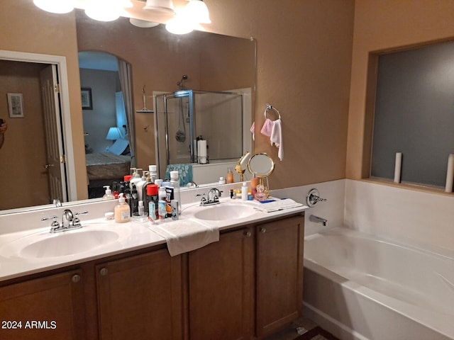 bathroom with separate shower and tub and dual bowl vanity