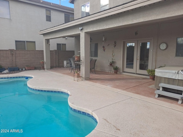 view of pool featuring a hot tub, french doors, and a patio area