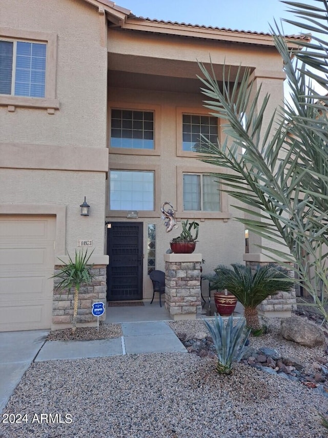 doorway to property featuring a garage