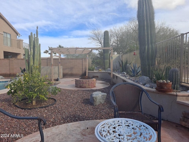 exterior space with a patio area, a fire pit, and a pergola