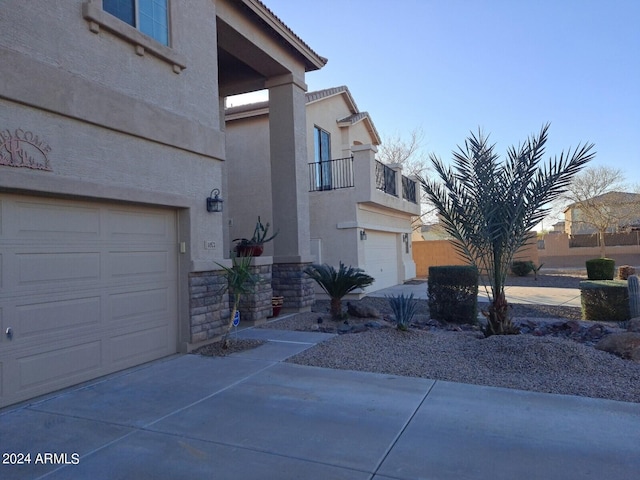 exterior space featuring a balcony and a garage