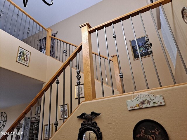 stairs featuring a high ceiling