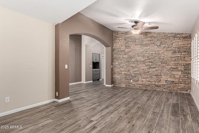 3028 W Parkside Ln, Phoenix, AZ 85027 - spare room featuring ceiling fan, wood finished floors, arched walkways, and lofted ceiling