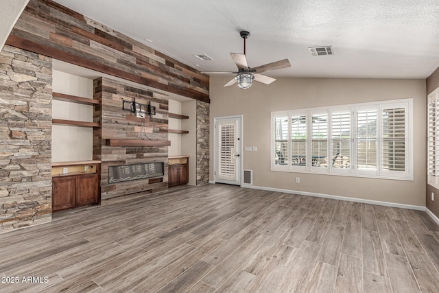 3028 W Parkside Ln, Phoenix, AZ 85027 - unfurnished living room featuring a glass covered fireplace, light wood-style flooring, vaulted ceiling, ceiling fan, and baseboards