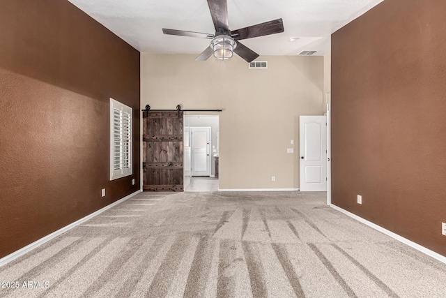 3028 W Parkside Ln, Phoenix, AZ 85027 - unfurnished living room featuring high vaulted ceiling, ceiling fan, a barn door, carpet flooring, and baseboards