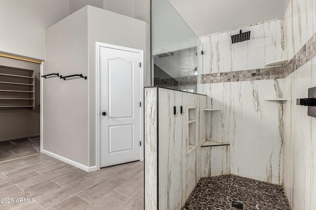 3028 W Parkside Ln, Phoenix, AZ 85027 - bathroom with a marble finish shower, wood finished floors, and baseboards